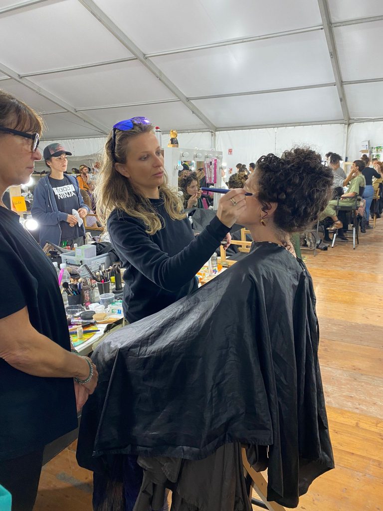 Chantal applying make-up to a member of the golden party