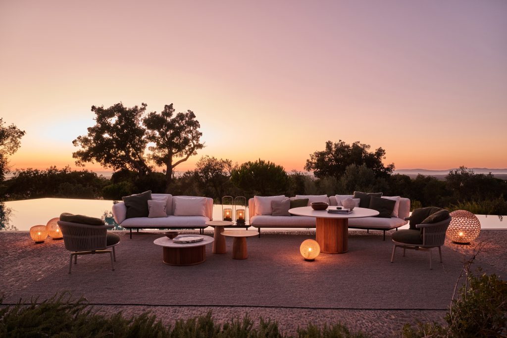 outdoor lounging area at sunset with chairs and tables low lighting