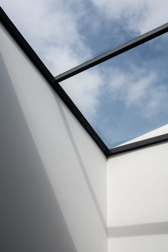 skylight with black frame looking onto the sky