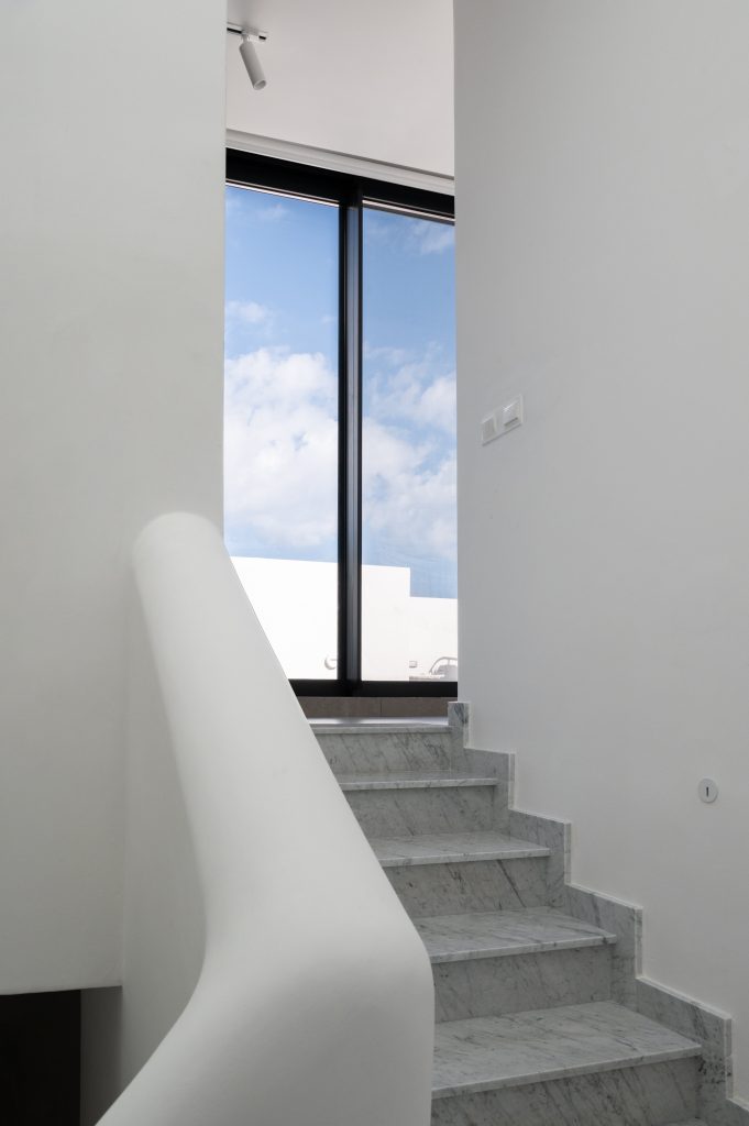 Internal marble staircase leading to whitewashed roof top