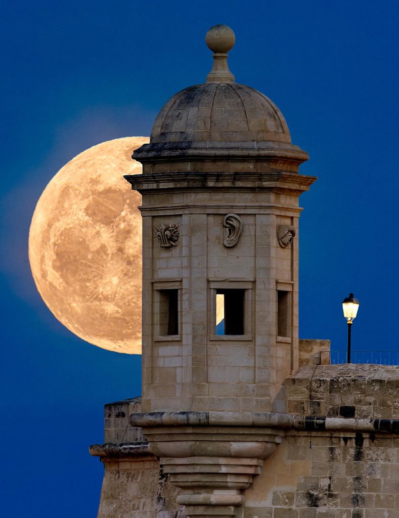 The first full moon of spring behind a Senglea gardjola / Photo by Daniel Cilia