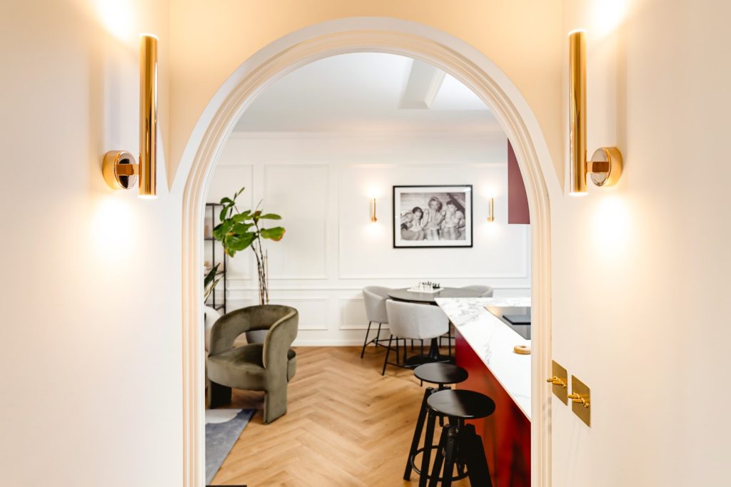 Orac wall moldings in the living/dining area and archway. Design by Lillie Helena Design House / Photography by Ruccya