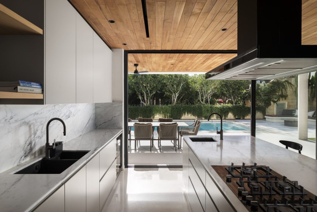 Ceiling cladding in teak, achieving continuity between indoors and out. Architecture and Design by CVC Architecture / Photography by Ramon Portelli